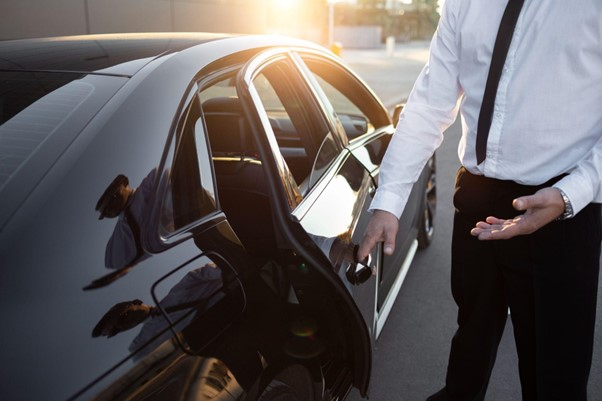 Chauffeur holding door open for passenger