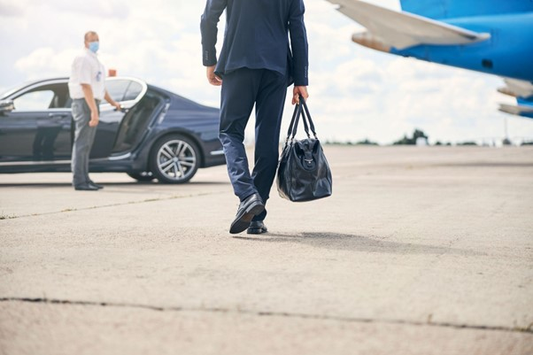 Chauffeur holding door open for passenger